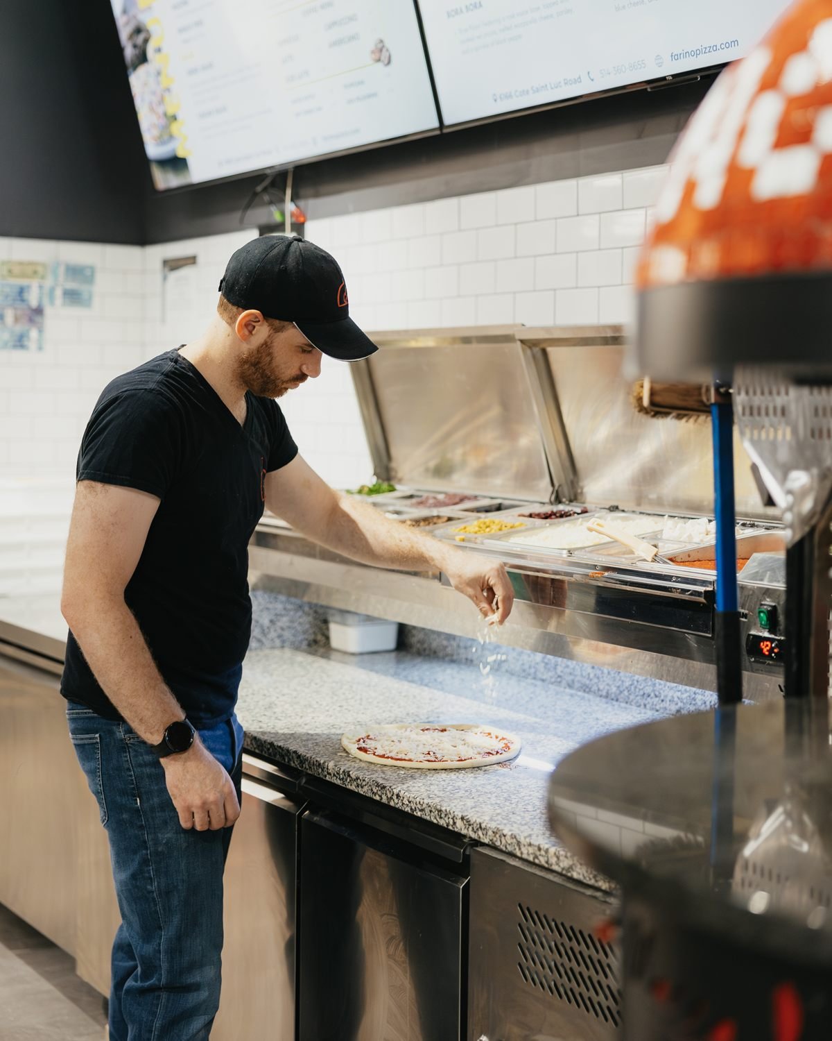Stretching and topping dough at the Farino counter